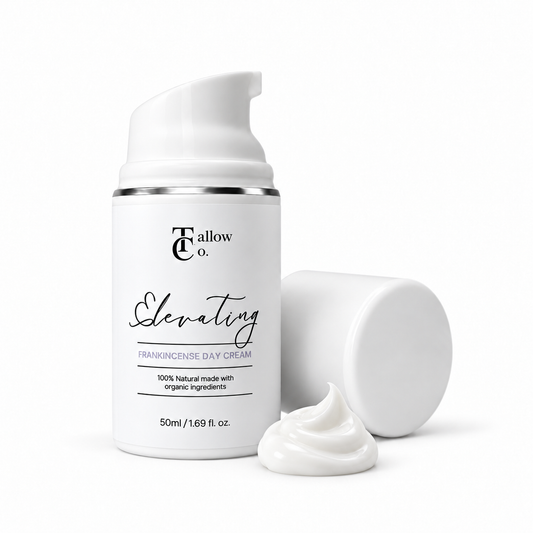 The Tallow Co. Elevating Frankincense Day Cream in a 50 ml white pump bottle with its cap and a glossy white cream swirl beside it.