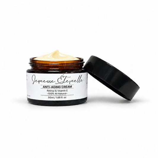 The Tallow Co. amber glass jar of Jeunesse Eternelle anti-aging cream with a black lid leaning against it, set against a clean white background.