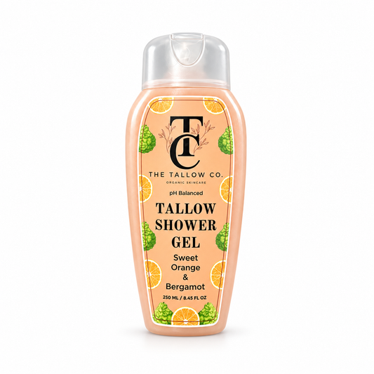 A bottle of Tallow Shower Gel by The Tallow Co. in the Sweet Orange & Bergamot scent, featuring a peach-colored bottle with a clear cap and a label decorated with orange slices and green bergamot illustrations.