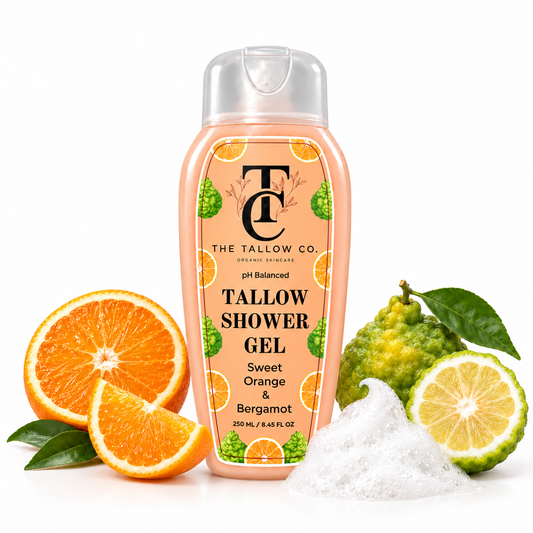 A bottle of Tallow Shower Gel by The Tallow Co. is centered on a white background, surrounded by citrus fruits (sliced oranges, bergamot, and lemon) and a pile of white shower gel.